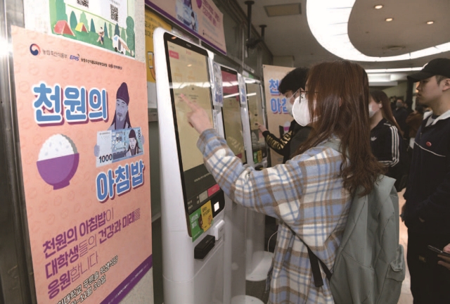 지난 3월 서울 동대문구 경희대학교 푸른솔문화관 학생식당에서 학생들이 ‘천원의 아침밥’ 식권을 구매하고 있다. 사진 뉴시스