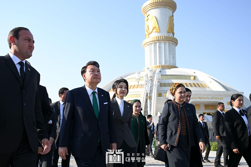 윤석열 대통령과 김건희 여사가 10일(현지시간) 투르크메니스탄 아시가바트 독립기념탑을 방문해 헌화 뒤 이동하고 있다.