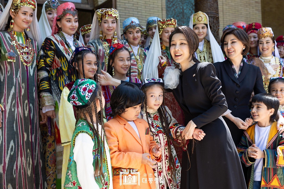 김건희 여사와 지로아트 미르지요예바(Ziroat Mirziyoyeva) 우즈베키스탄 영부인이 14일(현지시간) 우즈베키스탄 타슈켄트 대통령궁 히바동에서 배우자 문화 프로그램에 참가한 어린이와 인사하고 있다.