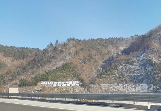 고속도로 주변에 평창 동계올림픽 개최를 알리는 홍보 문구가 보인다.